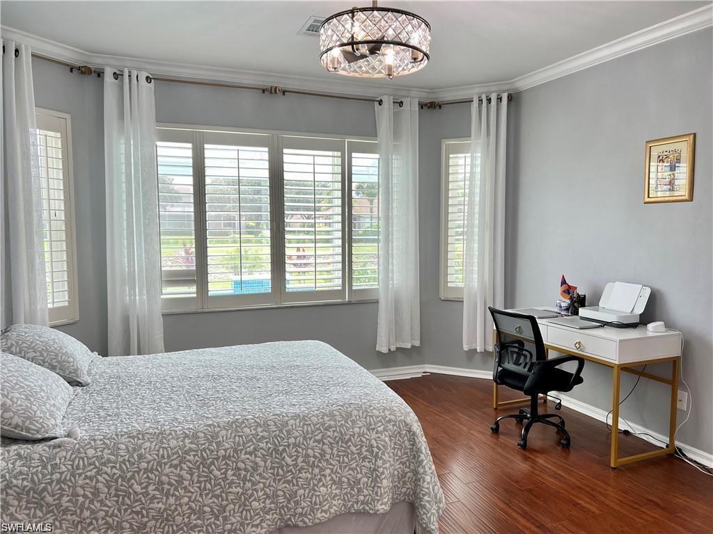 1812 Avian Court, Unit A78 Naples, FL 34119 - Photo 9 of 19 a bedroom with a bed and a large window