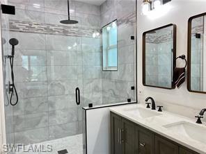 1812 Avian Court, Unit A78 Naples, FL 34119 - Photo 10 of 19 a bathroom with a granite countertop sink a mirror and shower