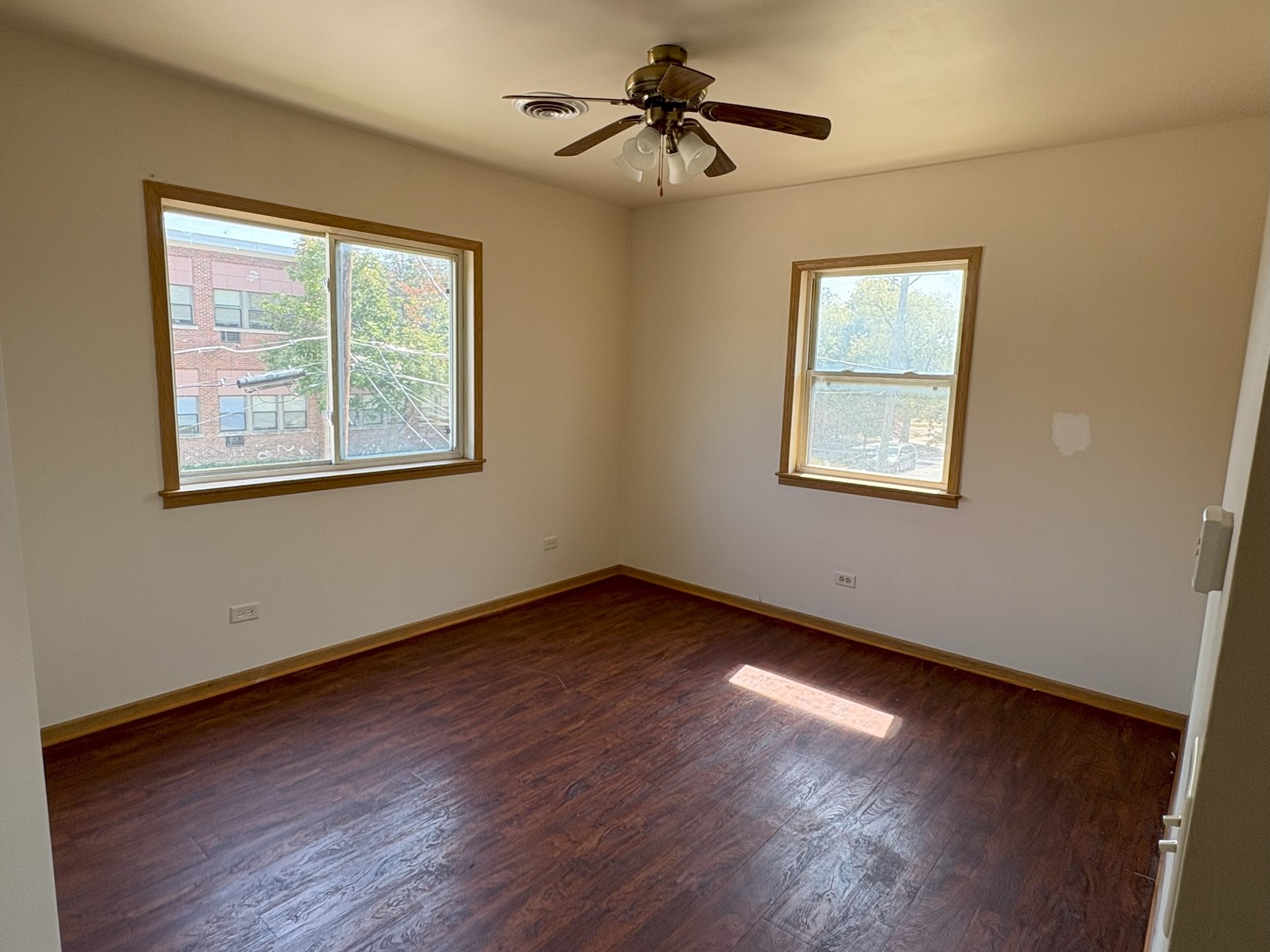 27 North Hickory Street, Unit 2B Joliet, IL 60435 - Photo 4 of 10 a view of an empty room with wooden floor and a window