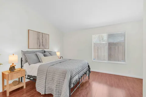 a bed sitting in a bedroom next to a window