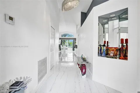 a kitchen with stainless steel appliances kitchen island granite countertop a stove refrigerator and microwave