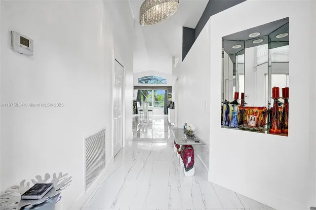 a kitchen with stainless steel appliances kitchen island granite countertop a stove refrigerator and microwave