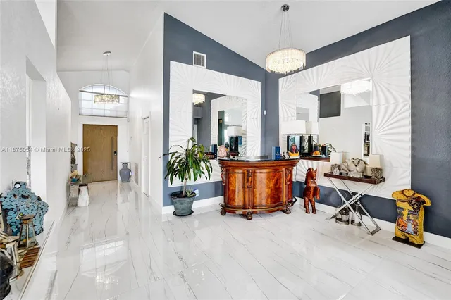 a kitchen with stainless steel appliances kitchen island granite countertop a stove a sink and a microwave