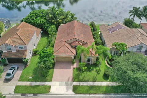 an aerial view of a city with lots of residential buildings lake and ocean view