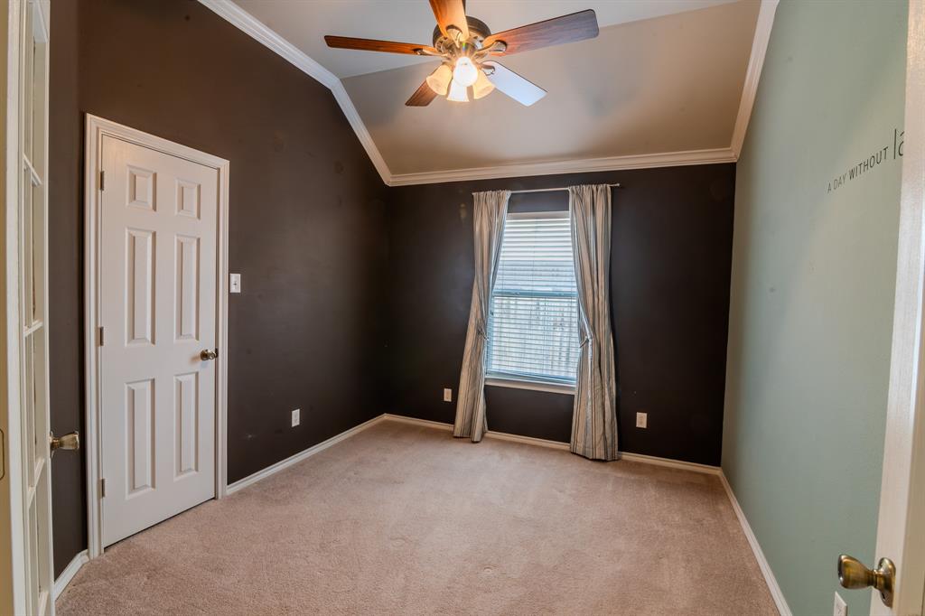 6014 Brenhaven Road Arlington, TX 76017 - Photo 14 of 18 Carpeted room featuring a ceiling fan with light fixture, vaulted ceiling, crown molding, and a window with blinds