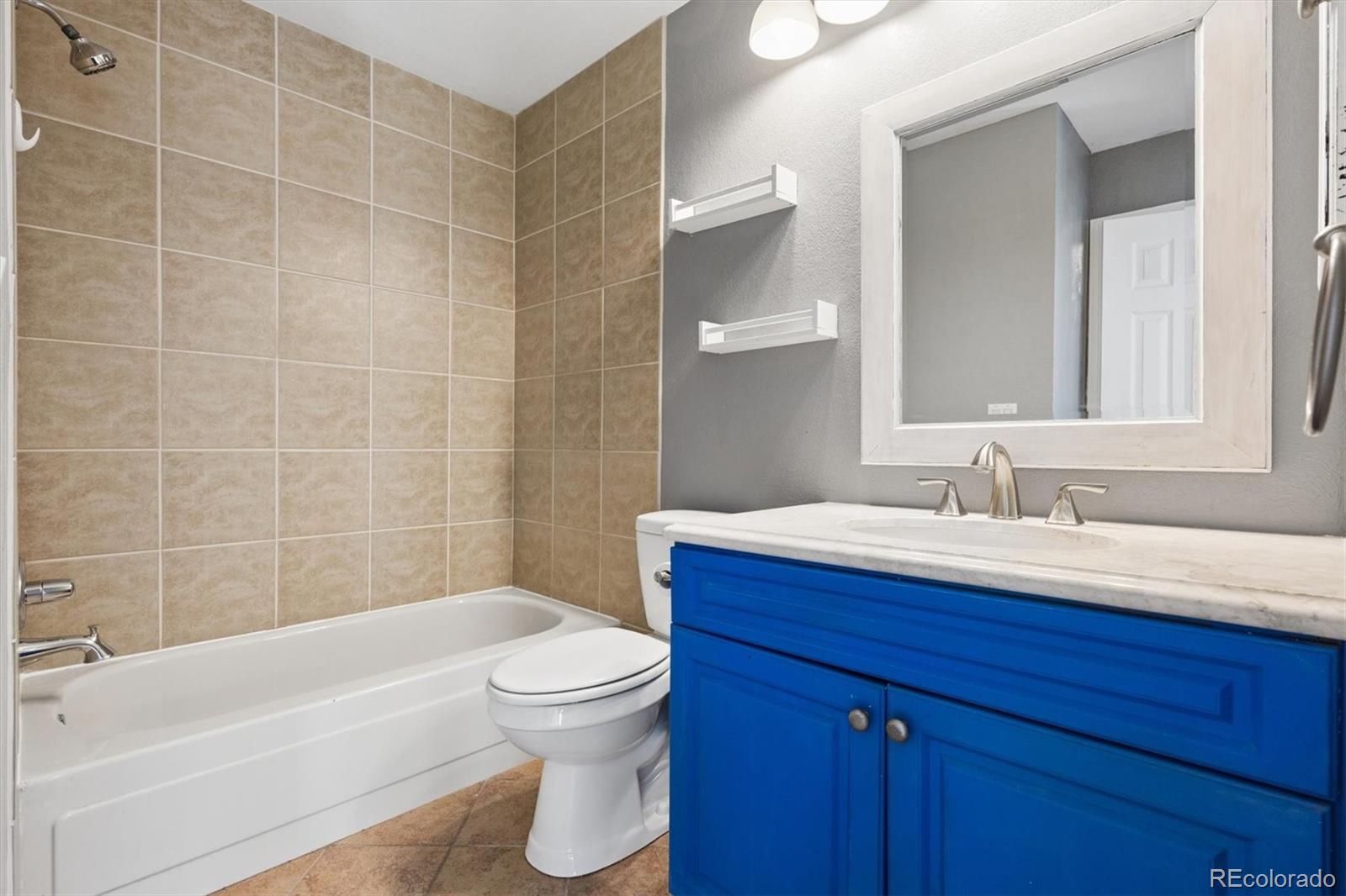 8139 South Fillmore Way Centennial, CO 80122 - Photo 13 of 29 a bathroom with a sink a toilet and shower