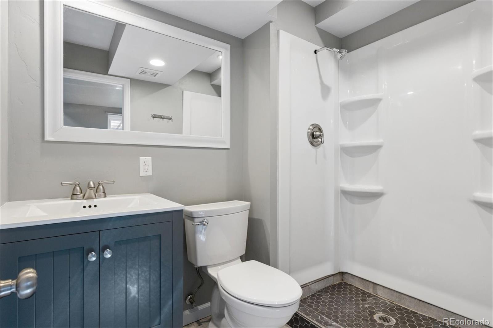 8139 South Fillmore Way Centennial, CO 80122 - Photo 21 of 29 a bathroom with a sink toilet vanity and shower