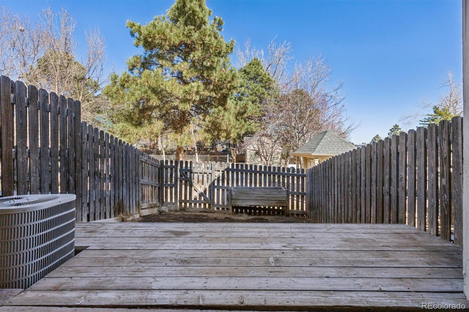 8139 South Fillmore Way Centennial, CO 80122 - Photo 25 of 29 a view of a deck with a wooden fence