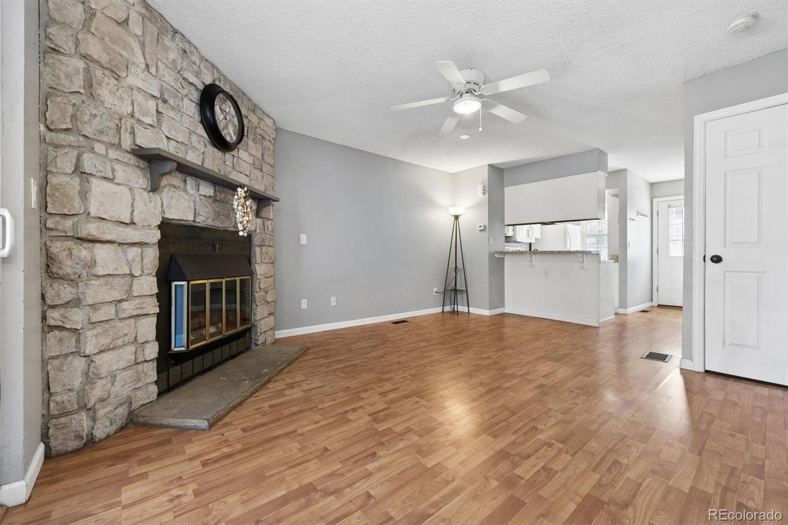 8139 South Fillmore Way Centennial, CO 80122 - Photo 3 of 29 a view of an empty room and fire place