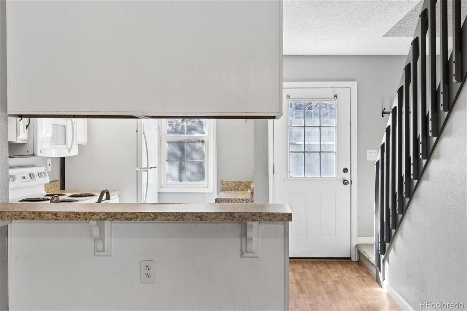 8139 South Fillmore Way Centennial, CO 80122 - Photo 5 of 29 a picture of a kitchen with a sink and cabinets