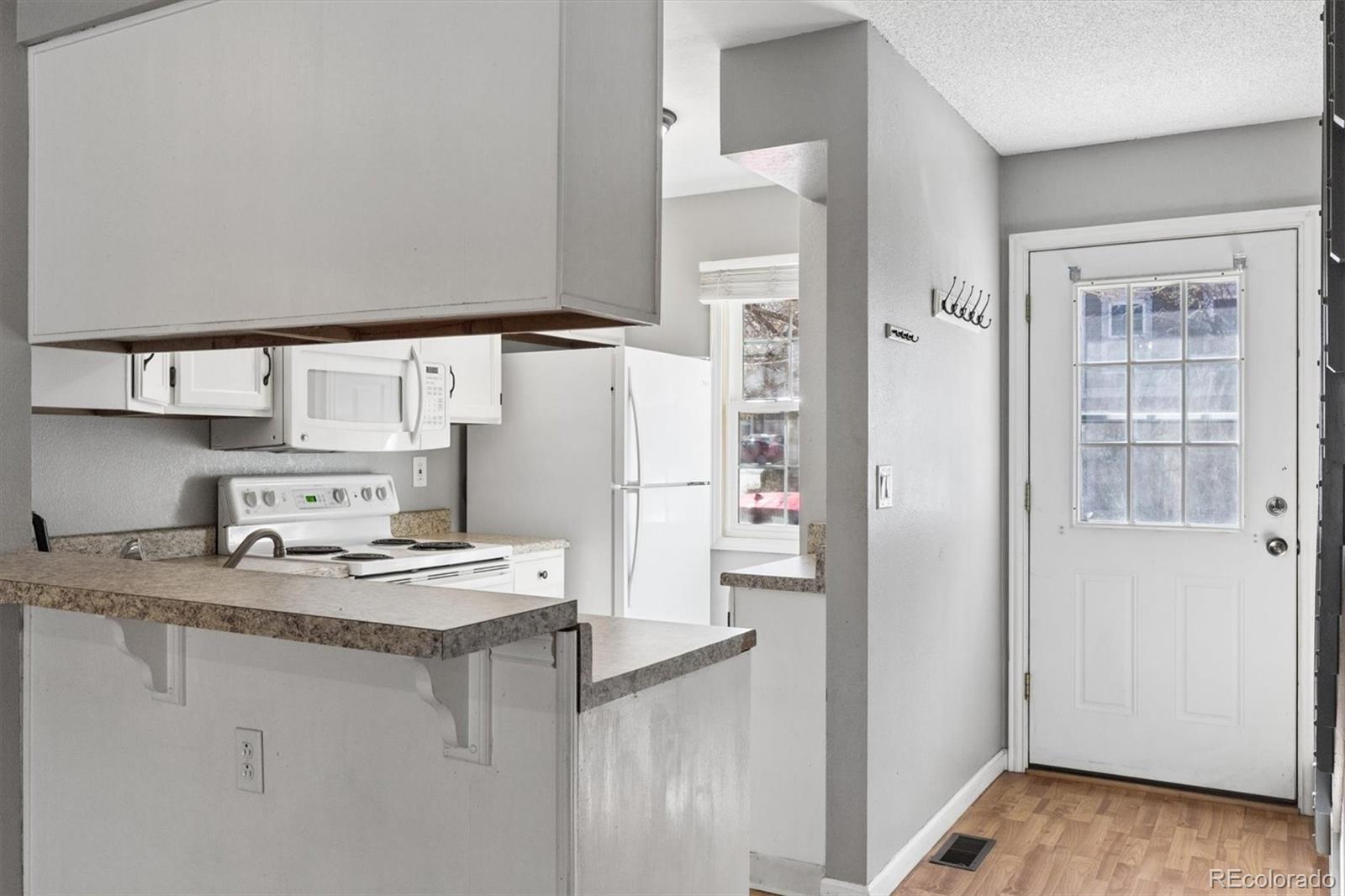 8139 South Fillmore Way Centennial, CO 80122 - Photo 9 of 29 a kitchen with stainless steel appliances a refrigerator and a stove