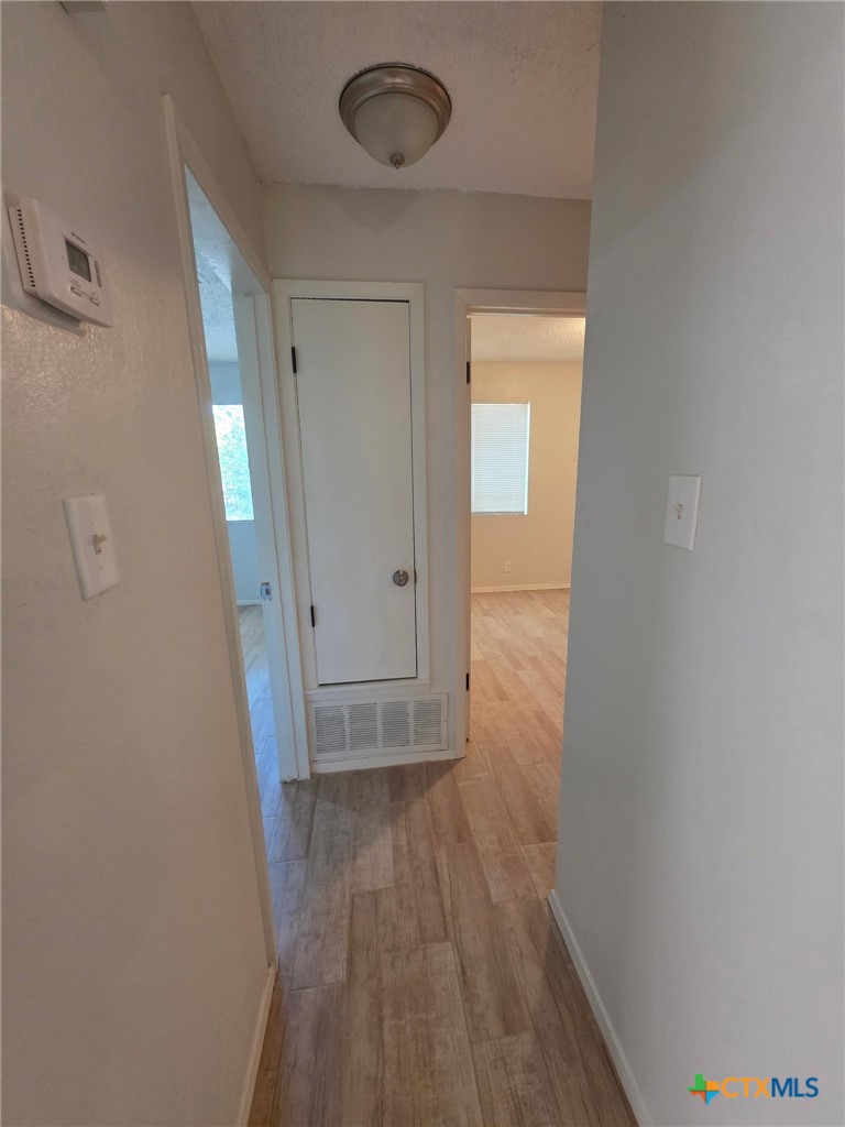 2010 South 15th Street, Unit B Temple, TX 76504 - Photo 3 of 12 a view of a hallway with wooden floor