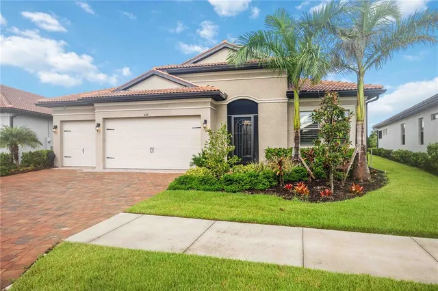 a front view of a house with a yard and garage