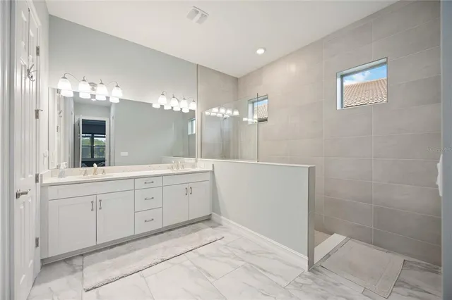 a large living room with stainless steel appliances kitchen island granite countertop furniture and a large window