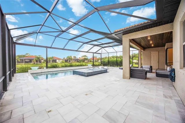 an aerial view of house with yard swimming pool and outdoor seating