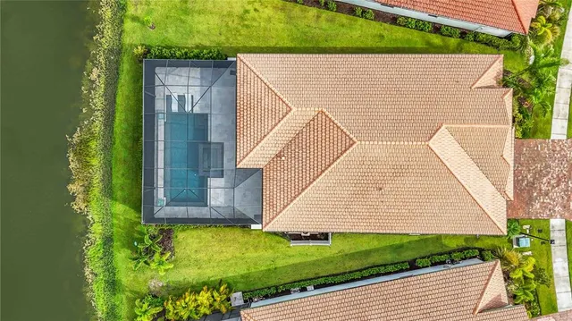 a living room with furniture a large window and a chandelier