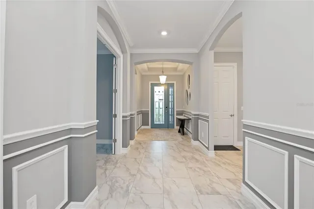 a view of a hallway with wooden floor and cabinet