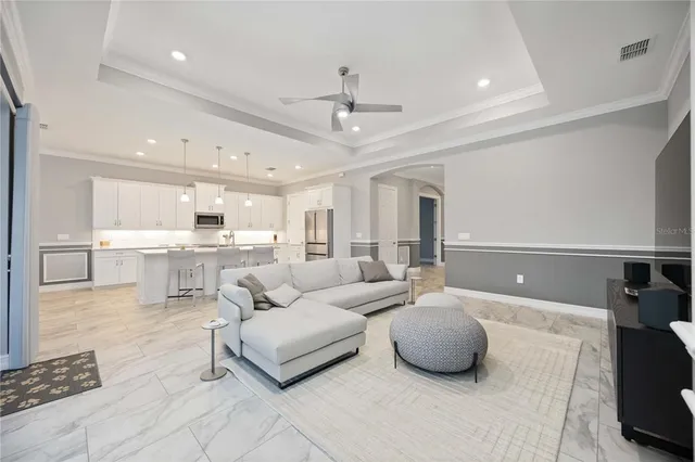 a living room with furniture a rug and a chandelier