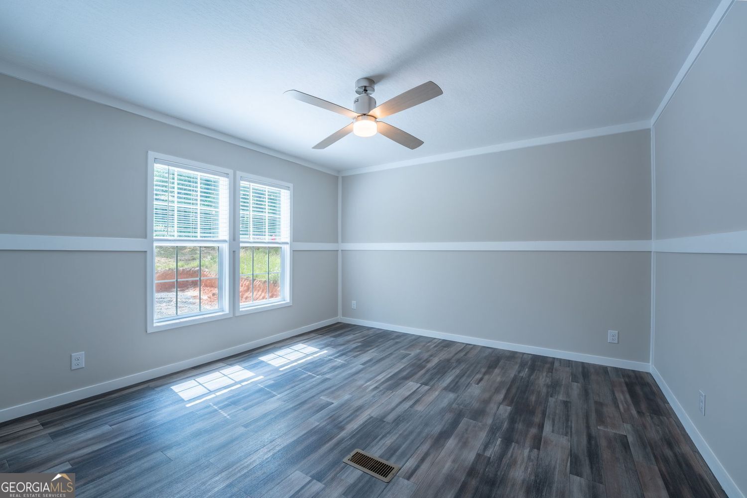 734 Hollywood Church Road Clarkesville, GA 30523 - Photo 24 of 49 an empty room with wooden floor and windows