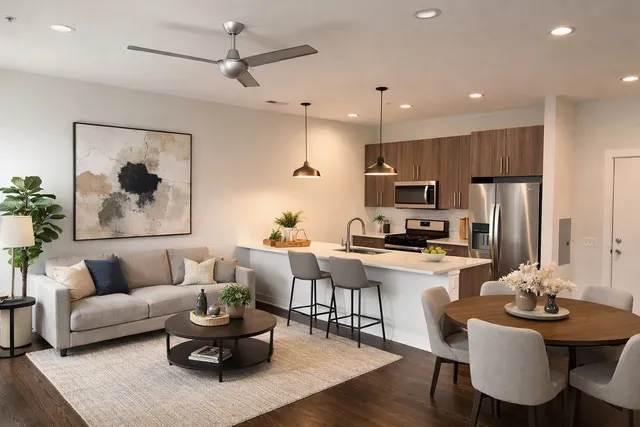 a living room with furniture kitchen view and a refrigerator