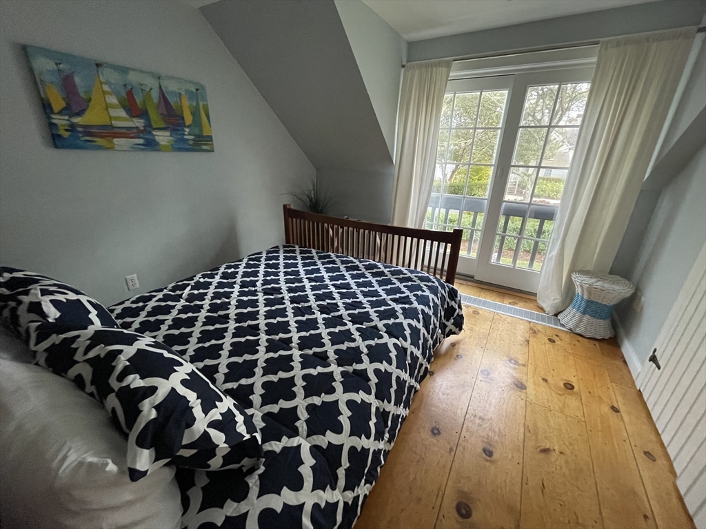 4 Colemans Way, Unit 702 Mashpee, MA 02649 - Photo 11 of 23 a bedroom with a bed and a window