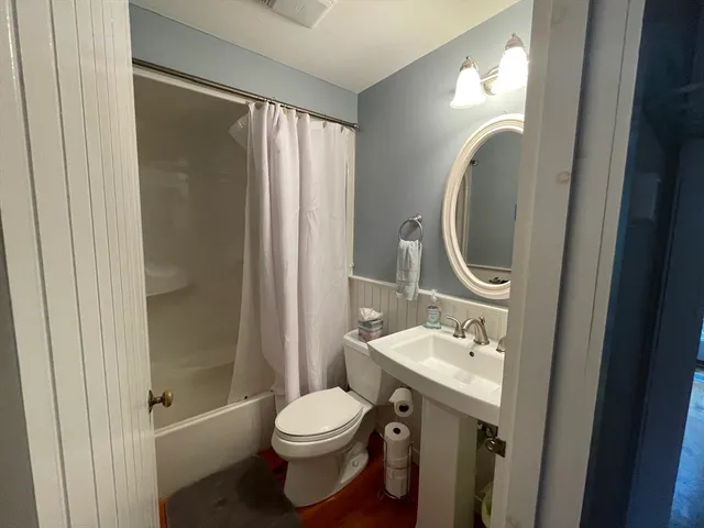 a bathroom with a sink toilet and shower