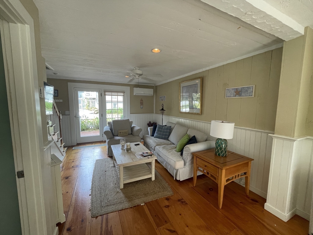 4 Colemans Way, Unit 702 Mashpee, MA 02649 - Photo 4 of 23 a living room with furniture and a wooden floor