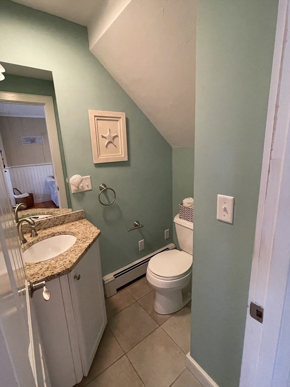 4 Colemans Way, Unit 702 Mashpee, MA 02649 - Photo 9 of 23 a bathroom with a granite countertop toilet sink and mirror