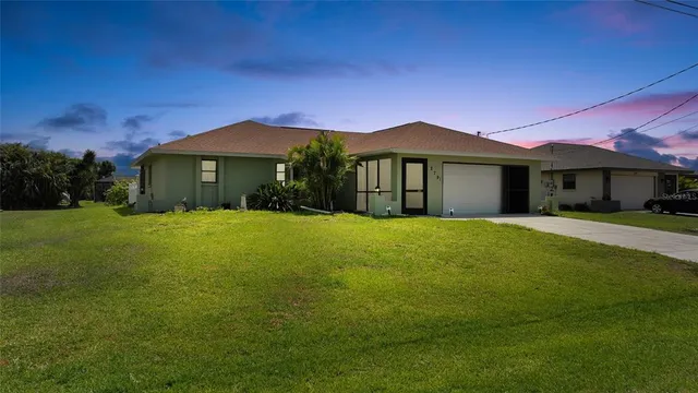 a front view of a house with yard and green space