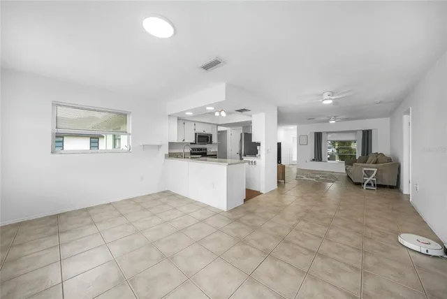 a bedroom with a bed and painting on the wall