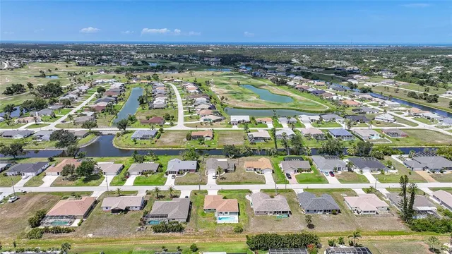 an aerial view of residential houses with outdoor space and ocean view