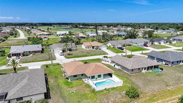 an aerial view of a houses with a swimming pool