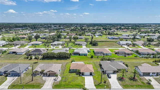 an aerial view of a house with a yard pool outdoor seating and yard