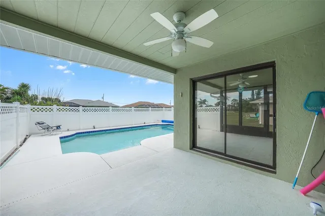 a view of a big yard with flower plants and large tree