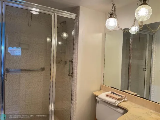 a bathroom with a mirror and a shower
