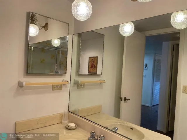a bathroom with a mirror and a shower