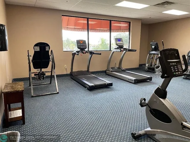 a room with gym equipment and windows
