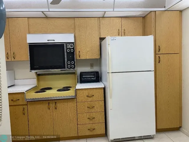 a white refrigerator freezer sitting inside of a kitchen