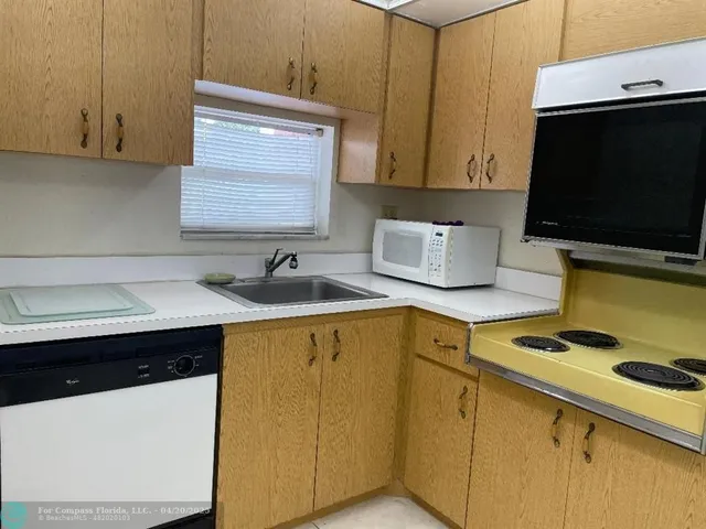 a kitchen with a sink and a stove top oven