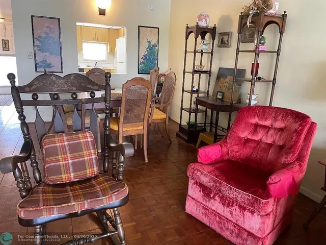a living room with furniture a rug and a floor to ceiling window