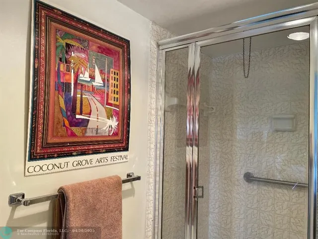 a bathroom with a shower and a glass door