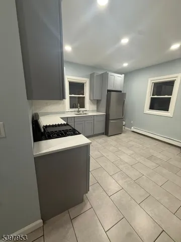 a kitchen with stainless steel appliances a refrigerator stove and microwave