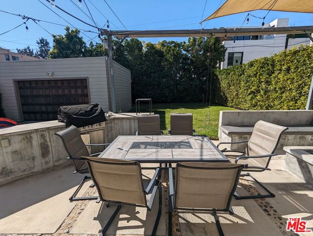 a view of a dinning table and chairs in the patio