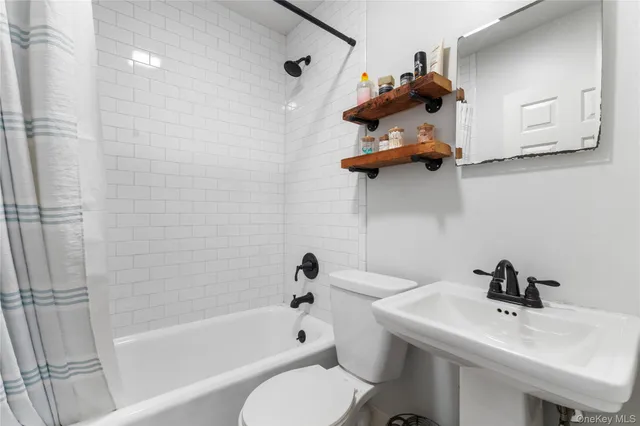a bathroom with a sink a toilet and bathtub