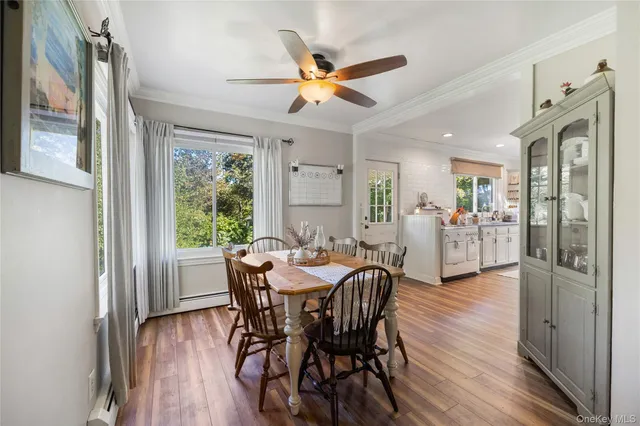 a view of a dining room with furniture window and wooden floor