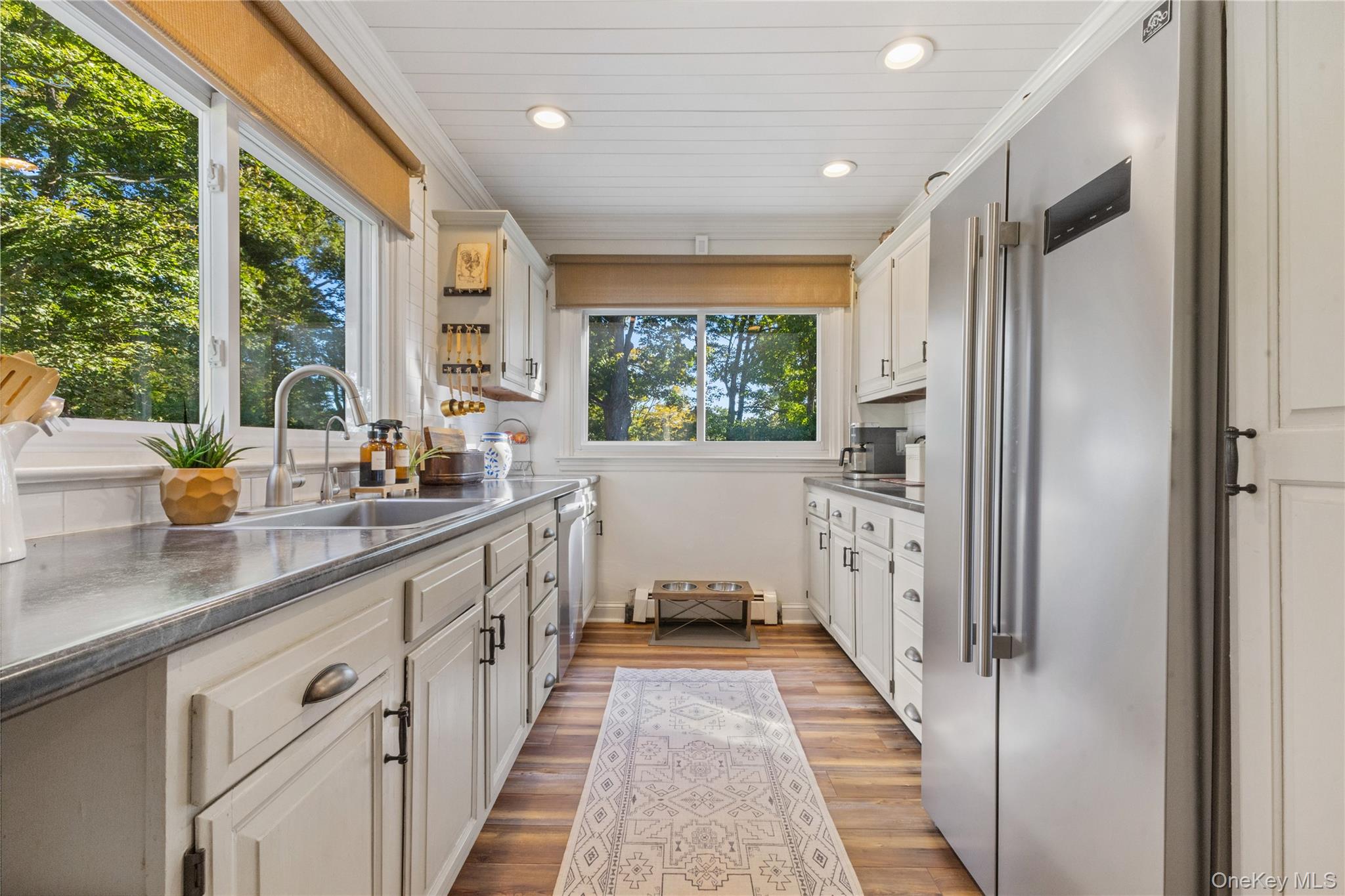 1645 Amazon Road, Unit 1645 Mohegan Lake, NY 10547 - Photo 29 of 50 a kitchen with white cabinets and a large window