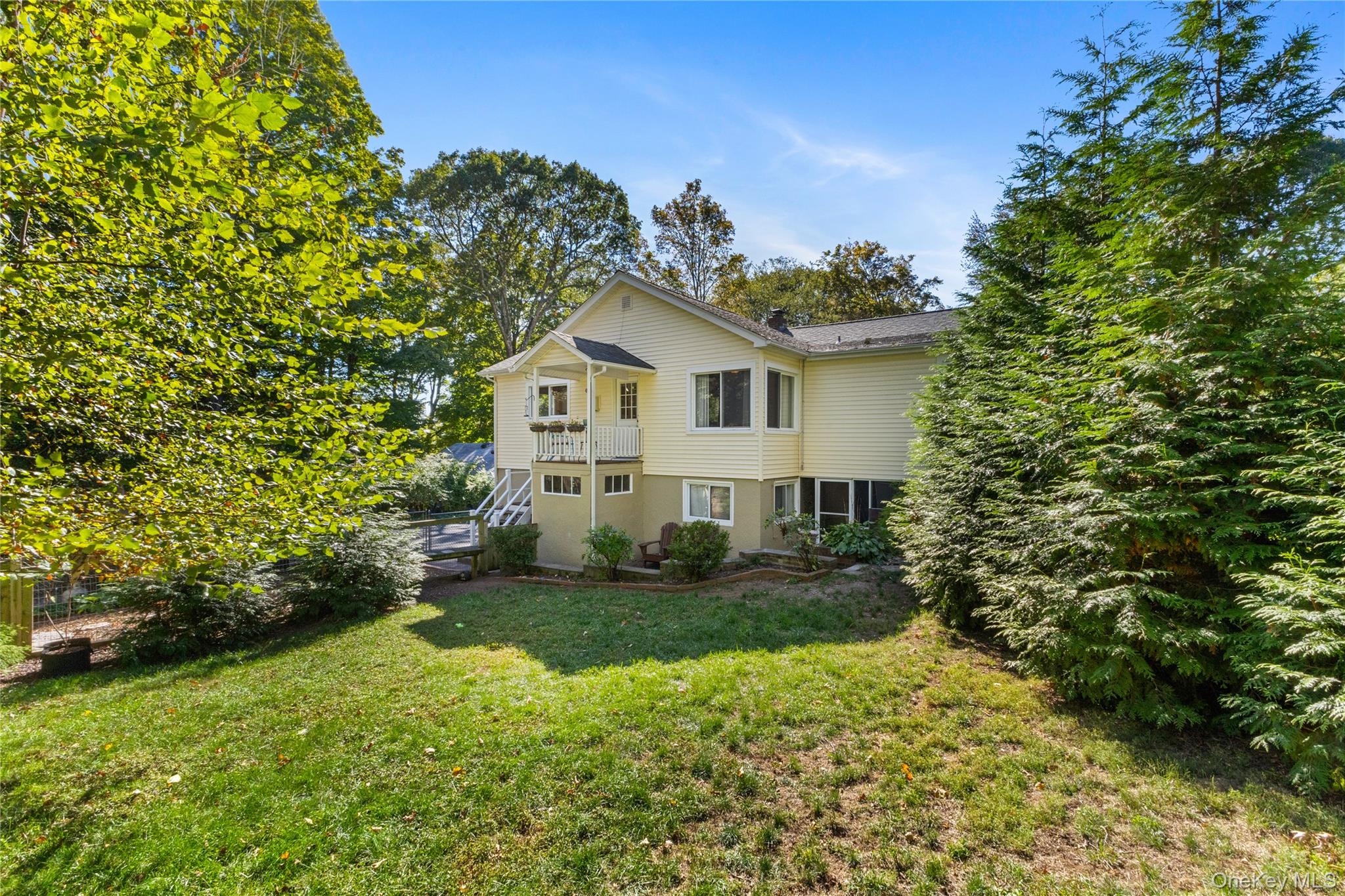 1645 Amazon Road, Unit 1645 Mohegan Lake, NY 10547 - Photo 39 of 50 a view of a house with a yard and potted plants