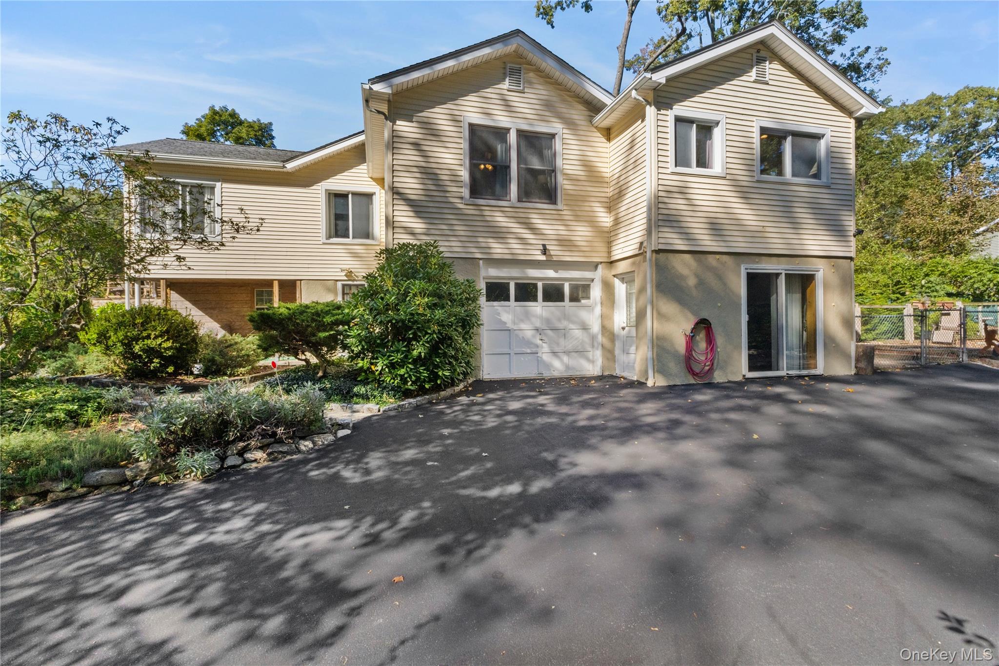 1645 Amazon Road, Unit 1645 Mohegan Lake, NY 10547 - Photo 40 of 50 a view of a white house with large windows and a small yard
