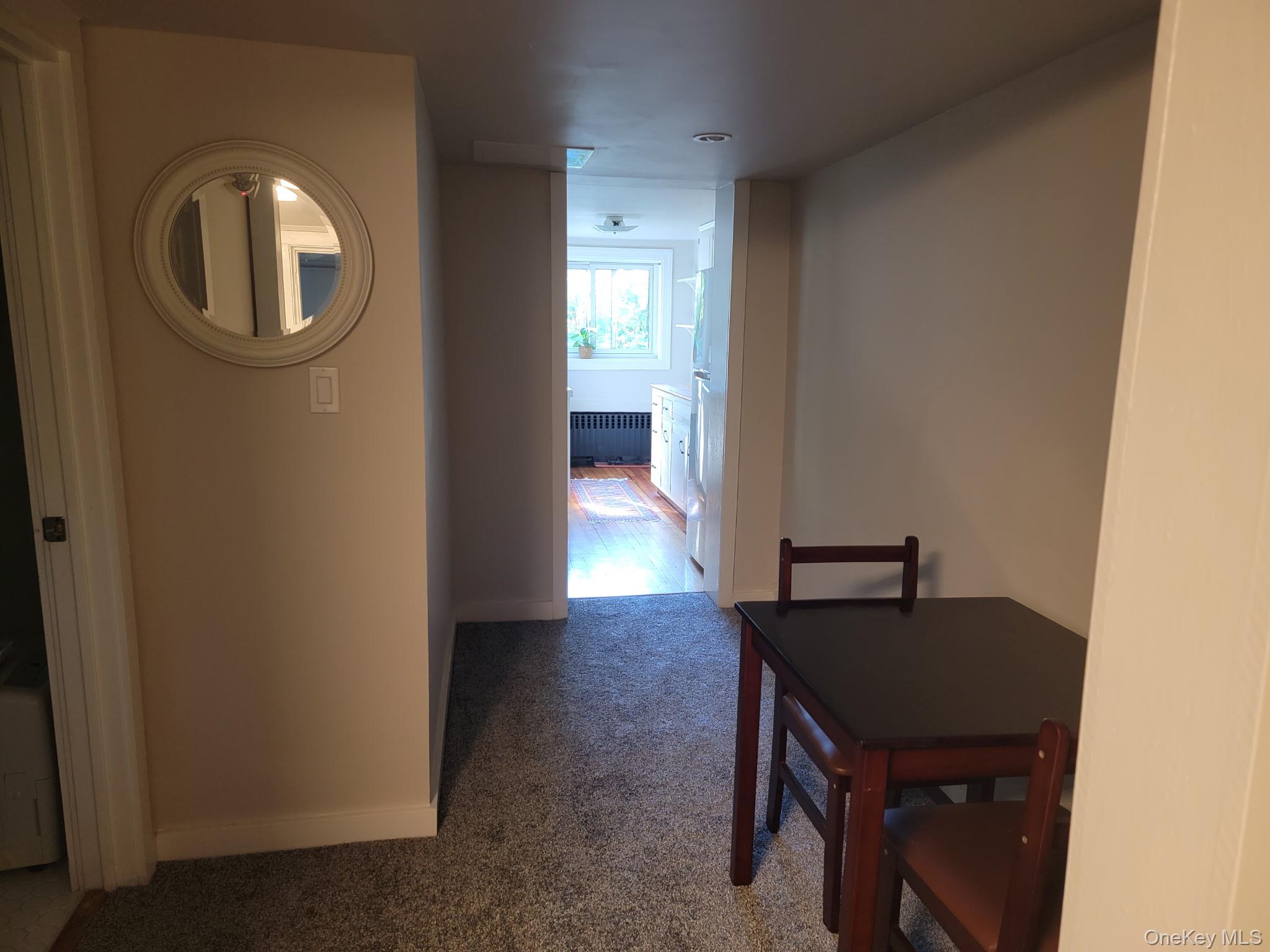1645 Amazon Road, Unit 1645 Mohegan Lake, NY 10547 - Photo 46 of 50 a view of a hallway with wooden floor and a bathroom