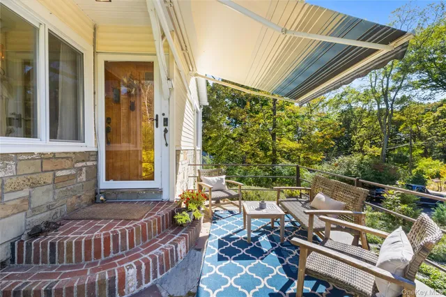 a balcony with wooden floor and outdoor seating